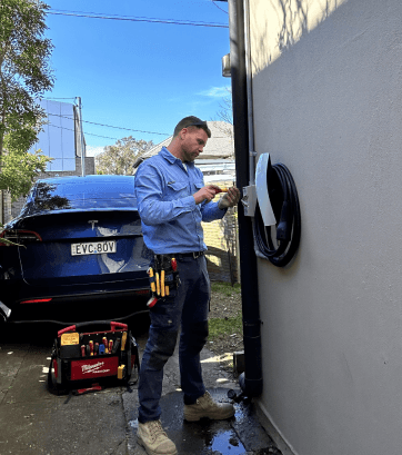 Electrician installing electric vehicle charger at a residential property in Sydney