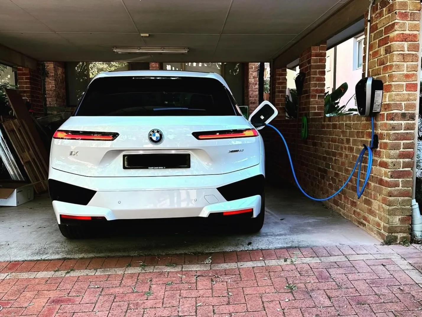 BMW electric vehicle charging at a residential property with a wall-mounted charger in Sydney